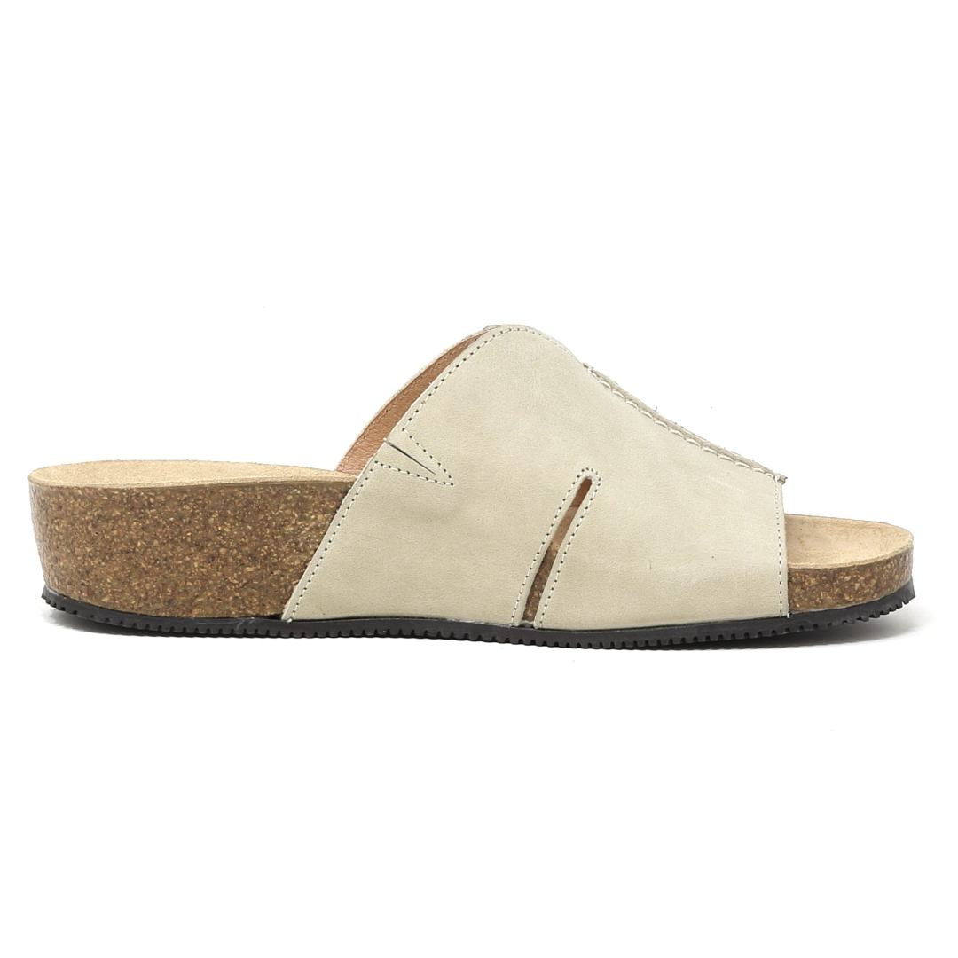 Introducing the Women's Layna Leather Wedge Sandal in beige, a slip-on design with a thick sustainable cork midsole, two cut-out details on the leather upper, and a cushioned suede footbed for ultimate comfort during stylish all-day wear.
