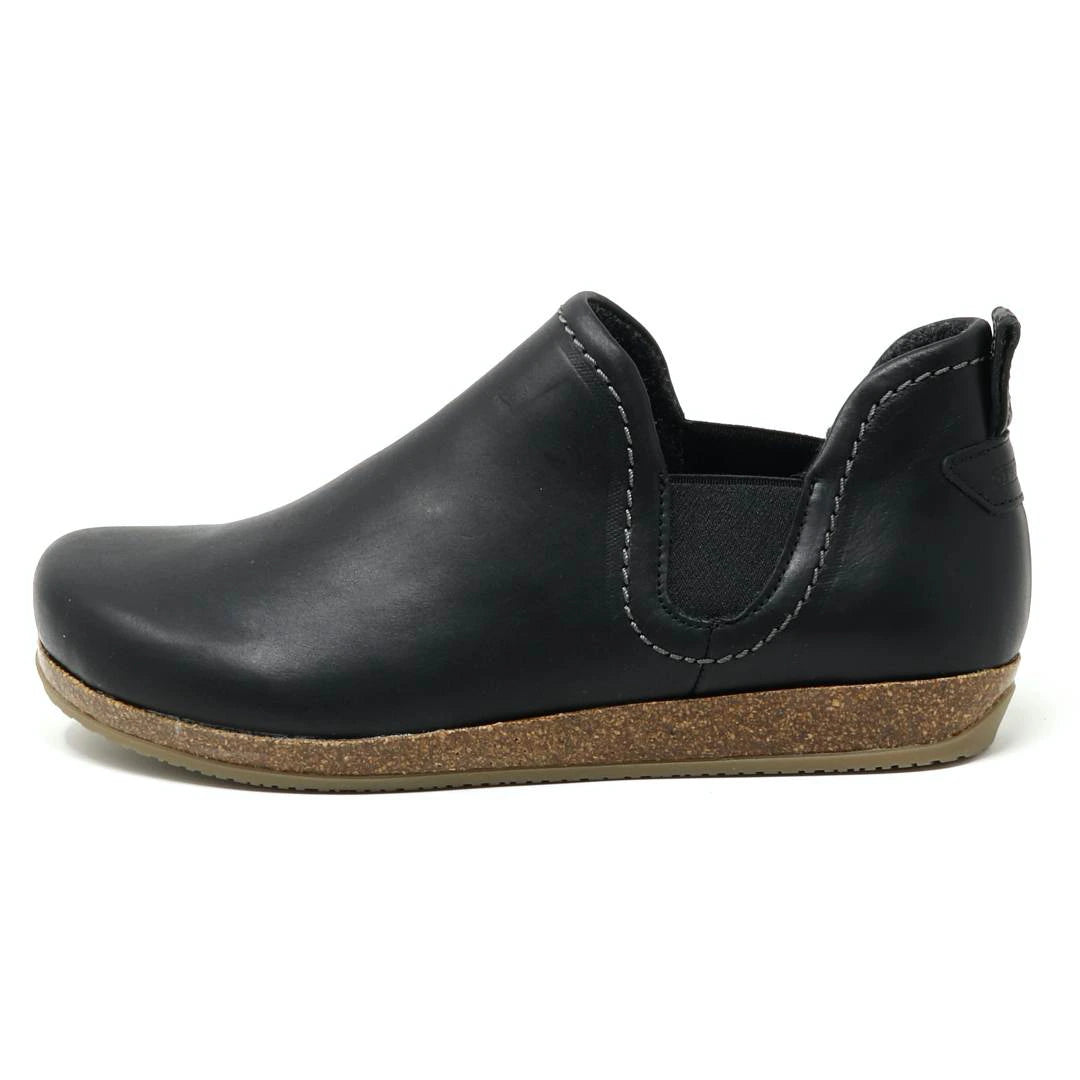 The Women's Lieben Leather Chelsea Boot is a black slip-on with a cork sole, elastic side panels, visible white stitching, and a cozy wool felt lining for comfort.