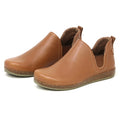 The Women's Lieben Leather Chelsea Boot is a brown Chelsea boot made from vegetable-tanned leather, with elastic side panels, rounded toes, and flat cork-textured soles.