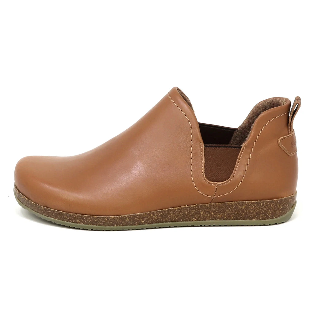 The Women's Lieben Leather Chelsea Boot is a brown, vegetable-tanned leather Chelsea boot with elastic side panels and a flat, textured sole, shown from the left side.