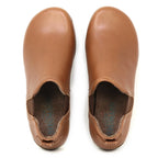 The Women's Lieben Leather Chelsea Boot is shown in tan vegetable-tanned leather with rounded toes, viewed from above against a white background.