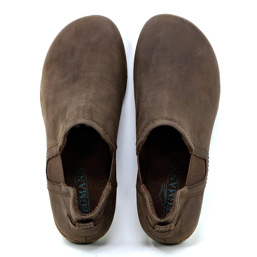 The Women's Lieben Leather Chelsea Boot is a brown, slip-on leather shoe with elastic side panels, branded insoles, and made from vegetable tanned leather, inspired by the classic Chelsea boot style.