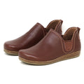 A pair of Women's Lieben Leather Chelsea Boots in brown vegetable-tanned leather with tan stitching and textured rubber soles, positioned side by side on a white background.