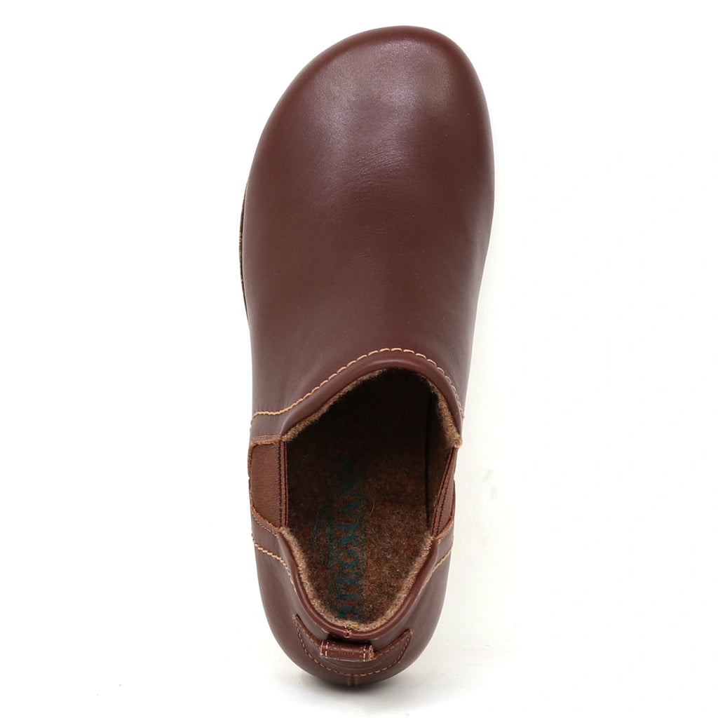 The Women's Lieben Leather Chelsea Boot features a brown slip-on design with vegetable tanned leather, visible stitching, elastic side panel, closed toe, and soft wool felt lining for comfort, shown from an above view.