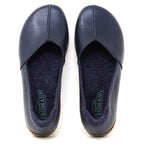 A pair of Women’s Liesl Leather Skimmer shoes in dark blue, featuring a wide toe box, visible stitching, soft gray insoles, and the brand name “Tegmann” printed inside.