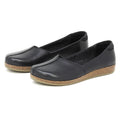 The Women's Liesl Leather Skimmer features black slip-on style, a wide toe box, cork soles, and a simple design, shown on a plain white background.