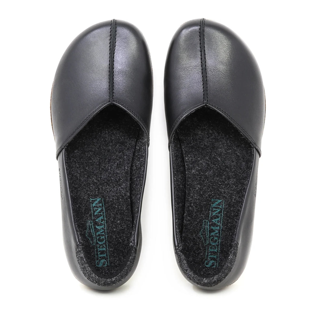 A pair of Women's Liesl Leather Skimmer slip-on shoes in black leather with a wide toe box, visible stitching, dark insoles, and "Stegmann" branding, viewed from above.