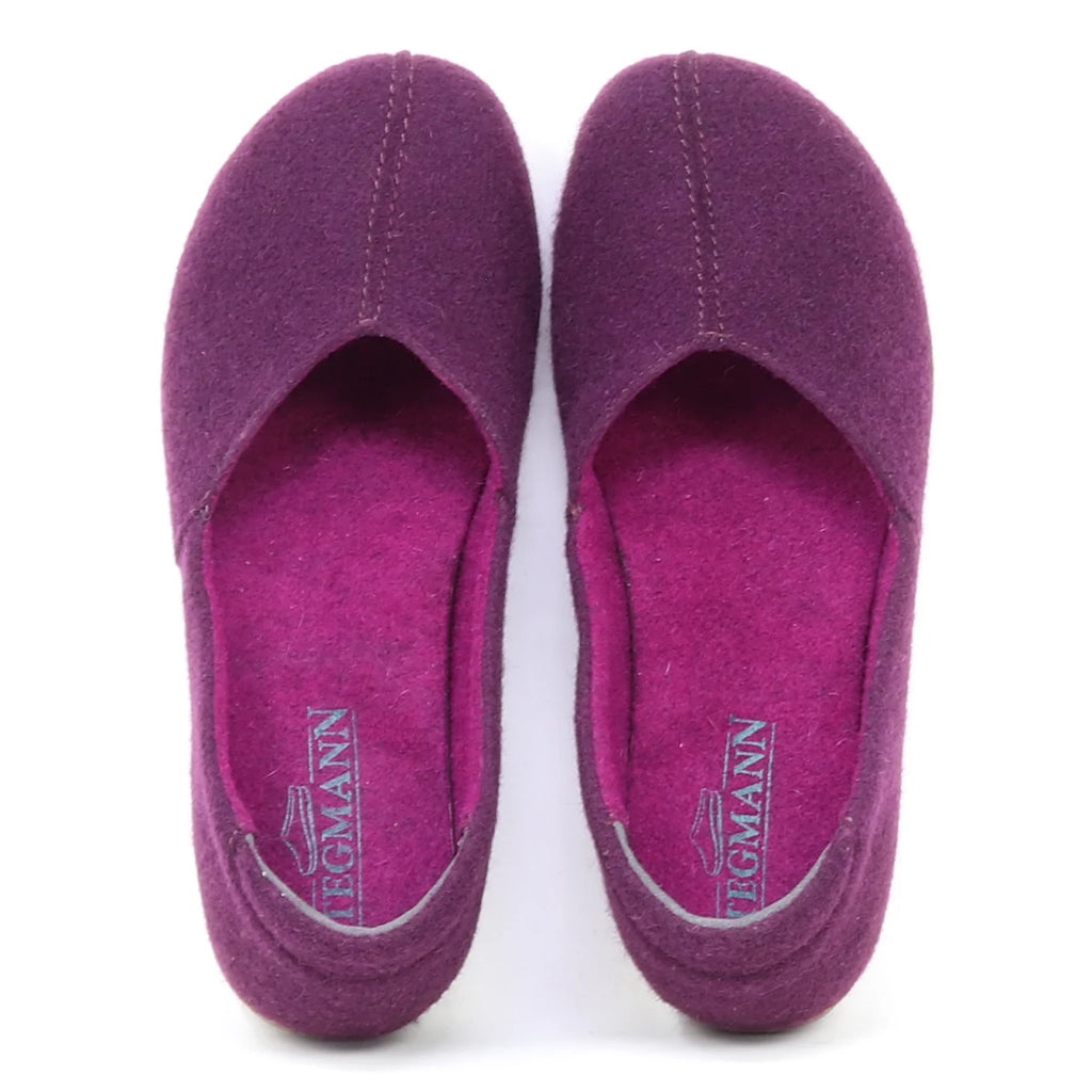 The Women's Liesl Wool Skimmer in purple felt features a wide toe box, visible stitching, and "Stegmann" insoles; this pair of women's slip-on wool shoes is shown from above.