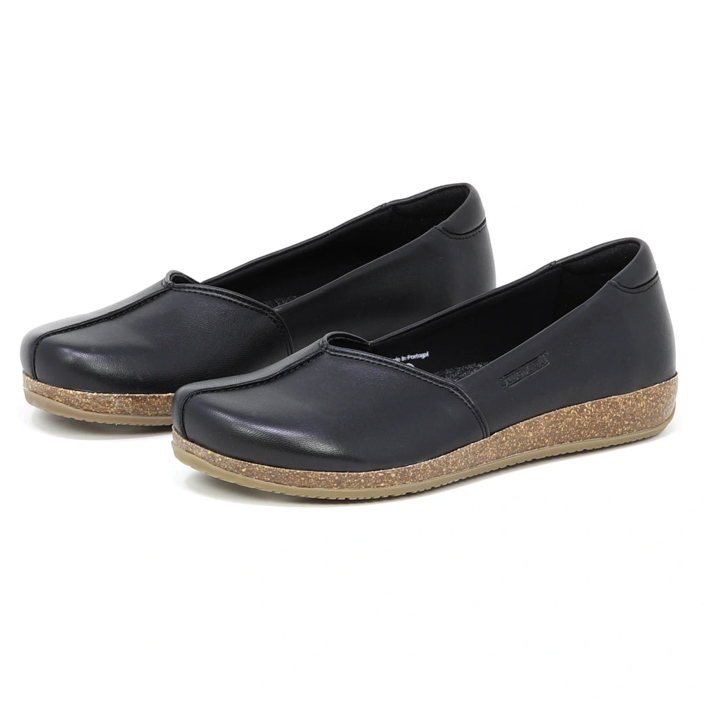 The Women's Liesl Stretch Leather Skimmer features black slip-on design, rounded toes, soft leather uppers, and tan rubber soles with a subtle wedge.