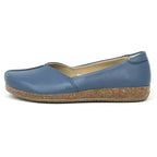 The Women's Liesl Stretch Leather Skimmer is a blue slip-on flat with buttery-soft leather and a cork-textured sole, shown in side profile on a white background.