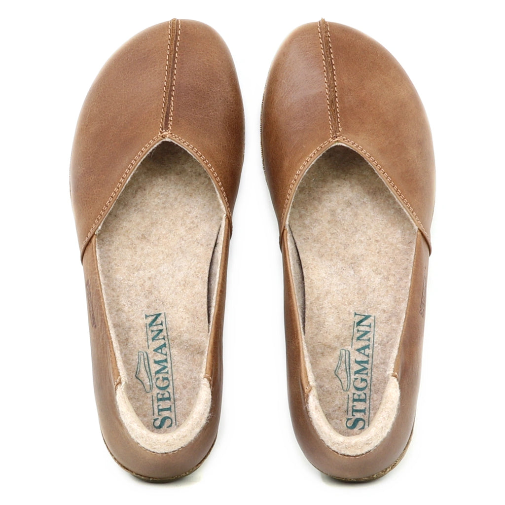 A pair of Women's Liesl Leather Skimmer shoes in brown leather with a wide toe box, rounded toes, and visible stitching, viewed from above. The insoles display the Stegmann brand logo.