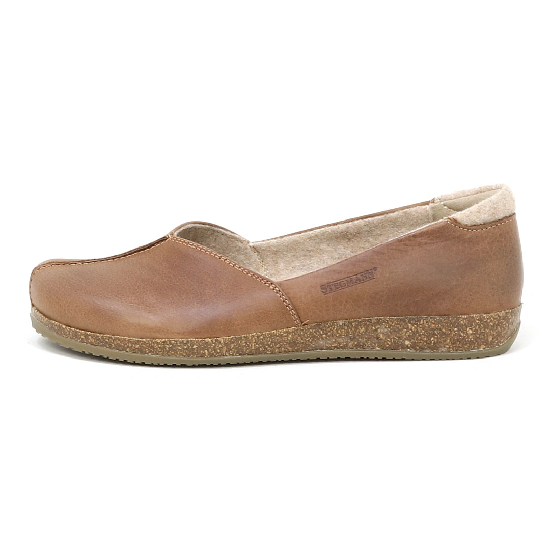 A Women's Liesl Leather Skimmer in brown leather with a cork sole, featuring a wide toe box, is shown in side profile on a white background.