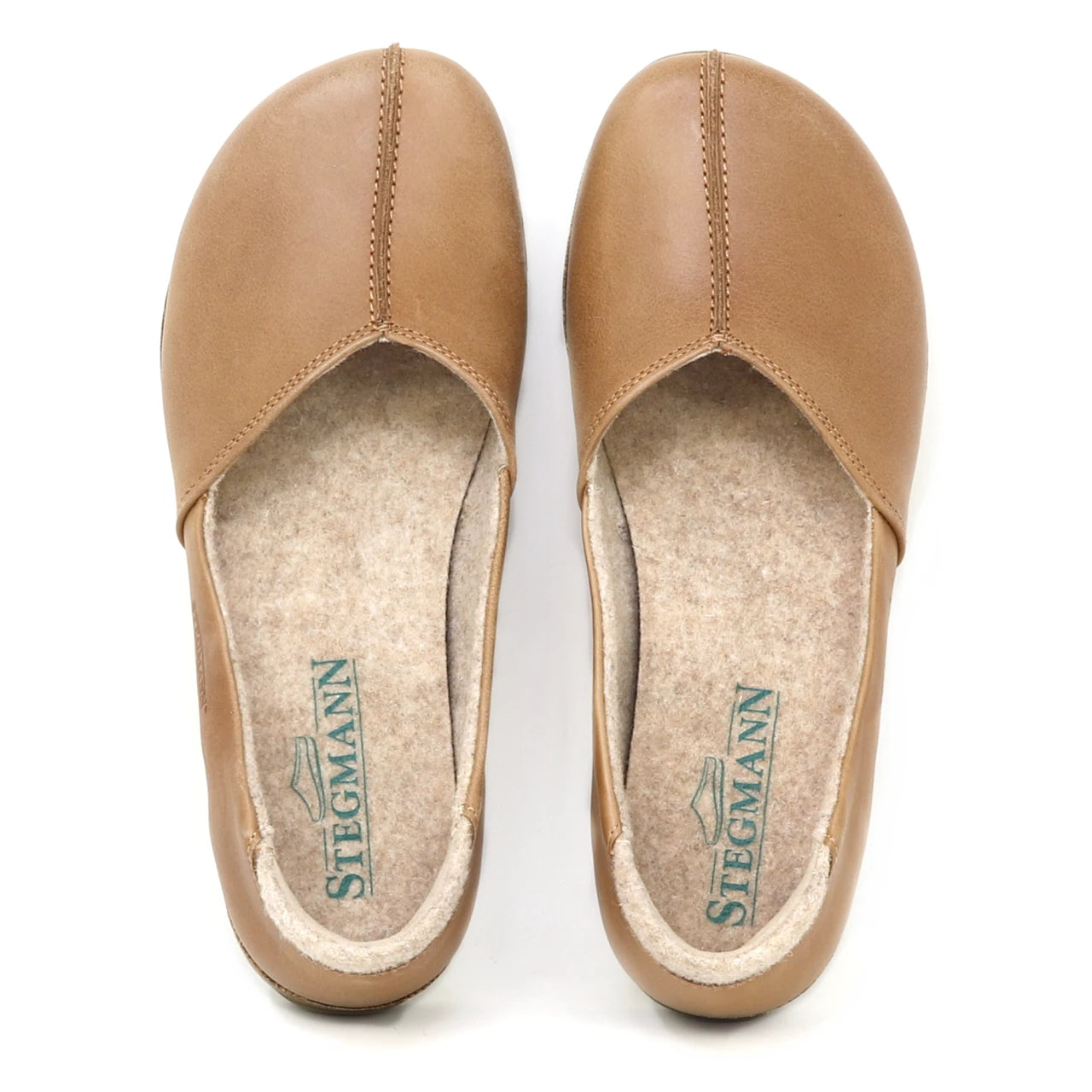 The Women's Liesl Leather Skimmer is a tan leather slip-on shoe with a wide toe box, visible stitching, and felt insoles labeled "STEGMANN" for arch support.