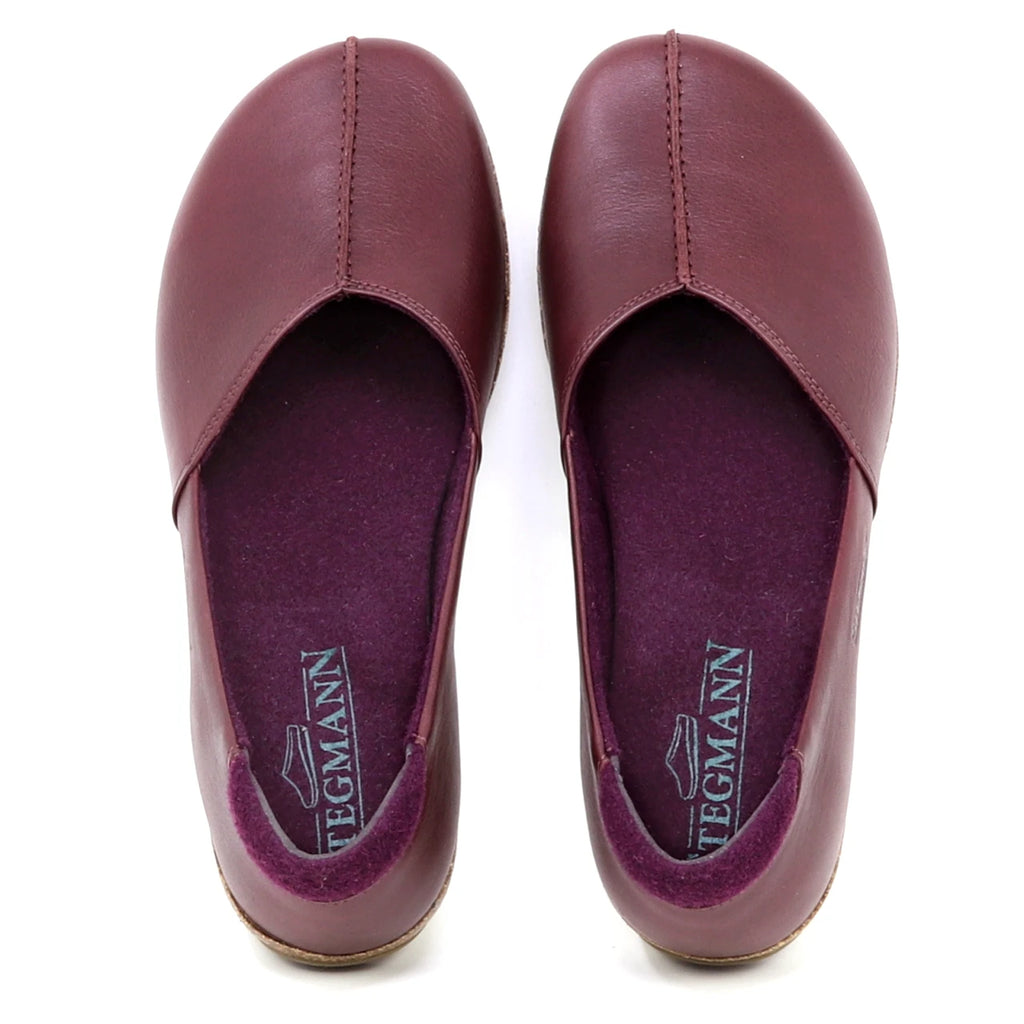 A pair of maroon Women's Liesl Leather Skimmer slip-on shoes with rounded toes and a wide toe box, shown from above on a white background.