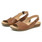 The Women's Louisa Leather Slingback Sandals feature brown leather with open toes, ankle straps, and cork soles, complemented by a cushioned footbed for extra comfort.