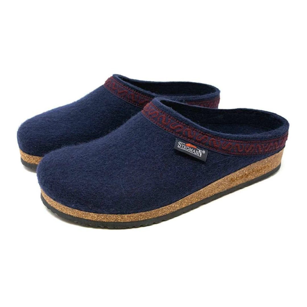Men’s Original 108 Wool Clog in navy blue felt with patterned trim, cork midsoles, and supportive rubber outsoles.