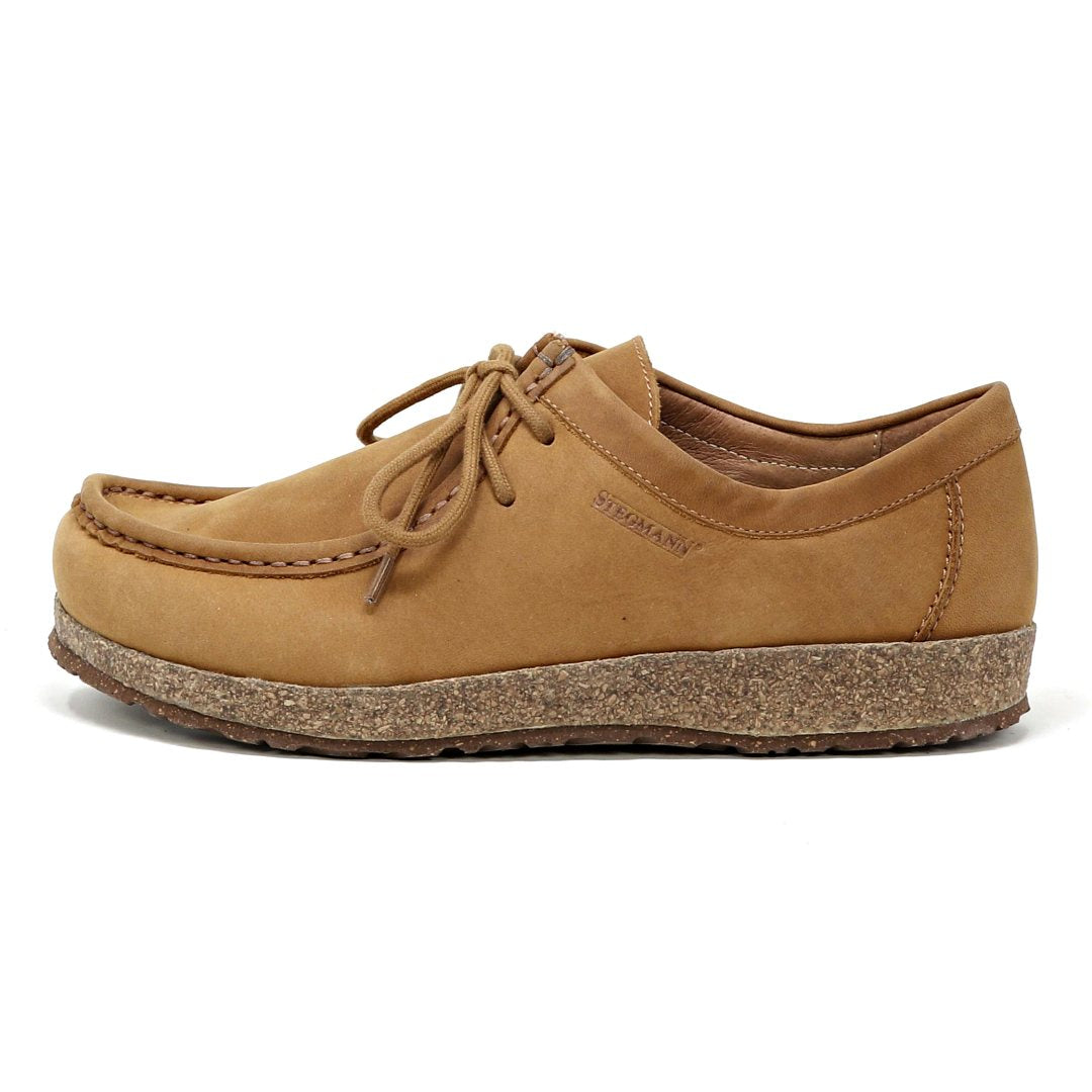 The Women's Mainz Leather Moc Shoe features a thick, textured cork sole and visible stitching, crafted from an oiled leather upper for enhanced durability, shown from the side.