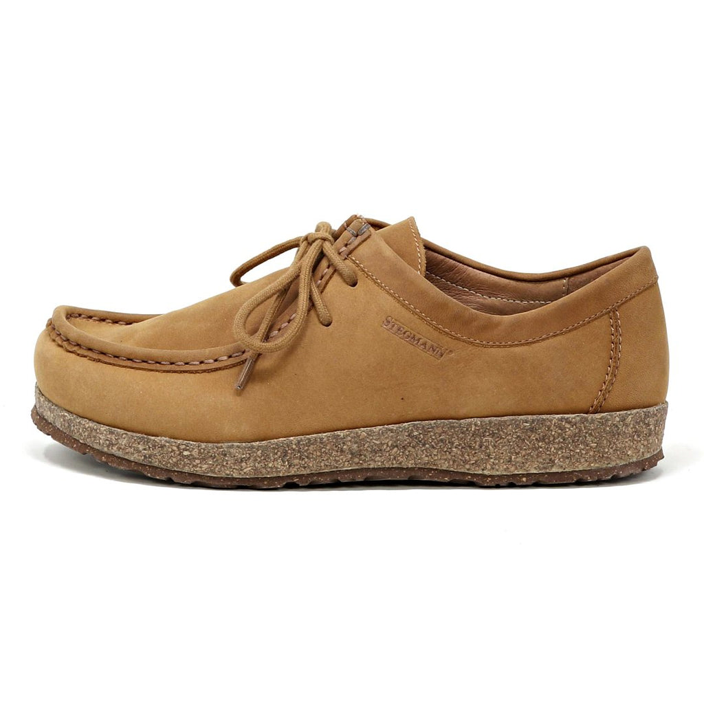 The Women's Mainz Leather Moc Shoe features a thick, textured cork sole and visible stitching, crafted from an oiled leather upper for enhanced durability, shown from the side.