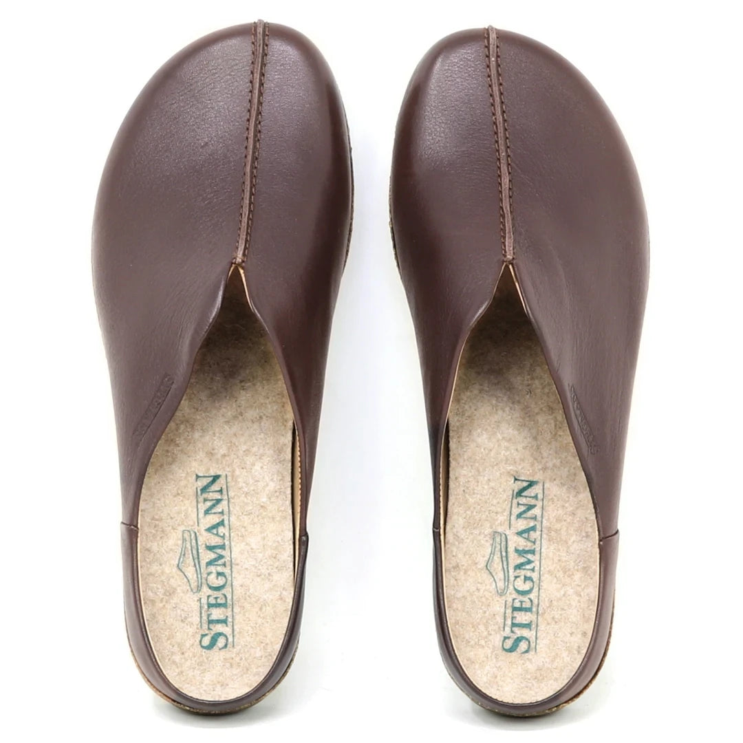 A pair of Women's Maria Leather Mule slip-on clogs in brown leather, seen from above. They feature a wide toe box, cork insoles branded "STEGMANN" with a shoe logo.