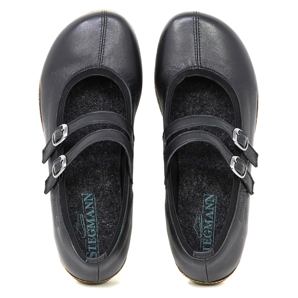 A top-down view of the Women's Marielle Stretch Leather Mary-Jane shoes in black, featuring double straps with silver buckles and built-in arch support, shown on a white background.