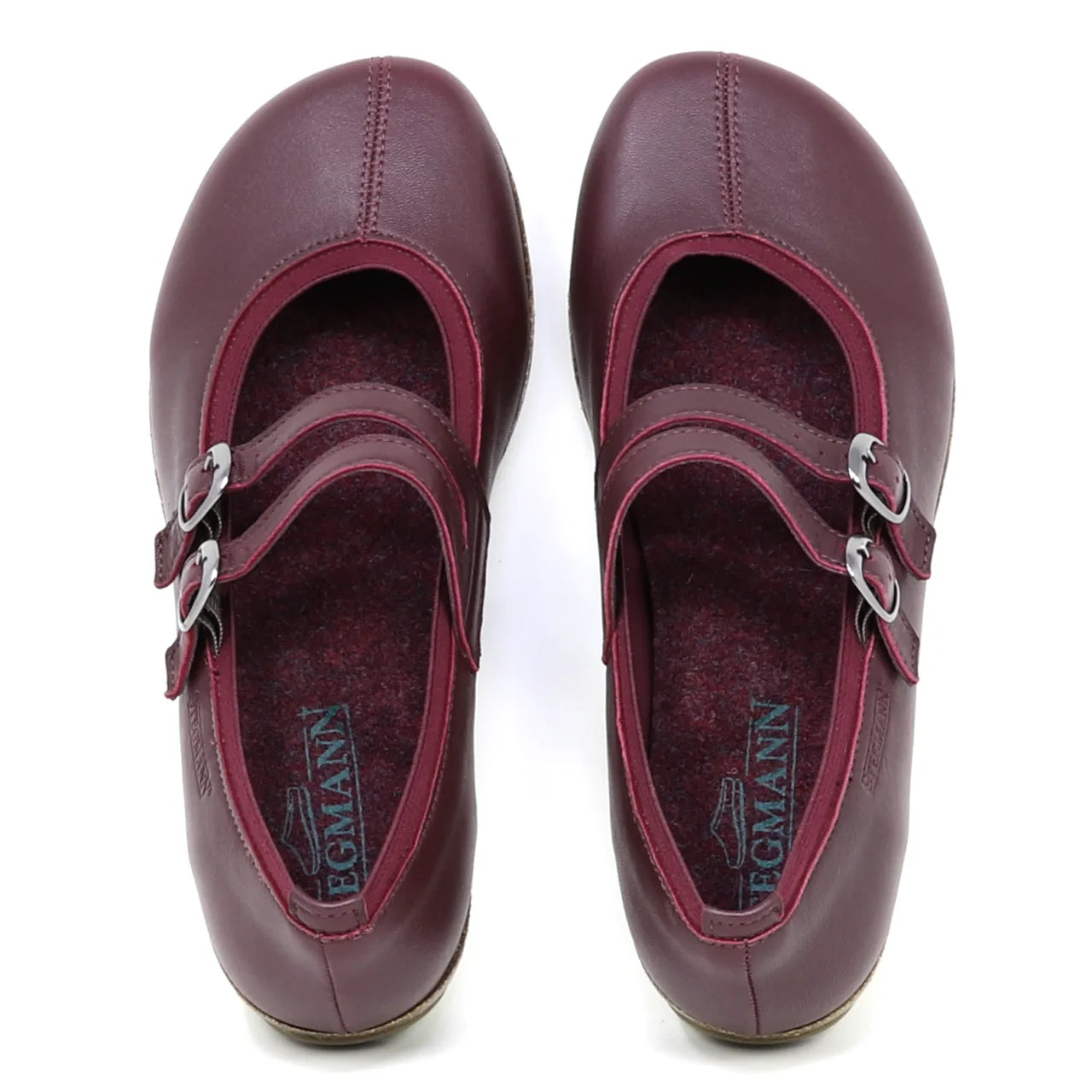 A pair of Women's Marielle Stretch Leather Mary-Jane shoes in maroon, featuring double buckle straps and arch support, is displayed from above on a white background.