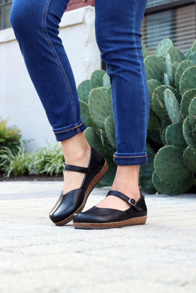 The 'Eva' Mary-Jane in Black. This shoe is cute, comfortable and offers incredible arch support. Lined with soft felt it can be worn barefoot or with socks. Removable insole. Loved by teachers, doctors and women who spend all day on their feet!