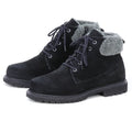 The Women’s Merano Chukka Boots—a pair of black suede lace-up ankle boots with gray fleece cuffs, rugged rubber soles, and a cozy wool shearling lining for added warmth—are positioned side by side on a white background.