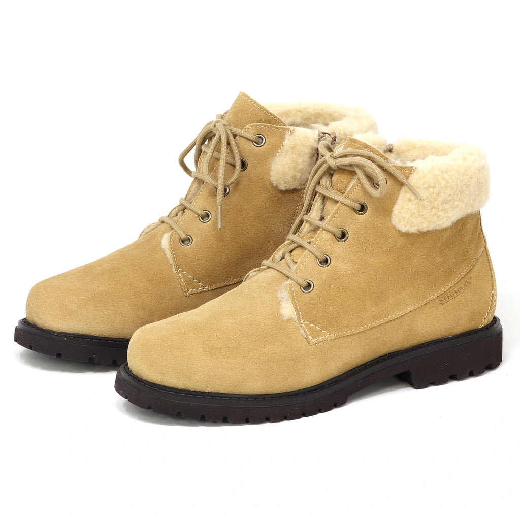 Women’s Merano Chukka boots in tan suede with cream-colored fleece lining and thick brown lug soles.