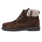 The Women’s Merano Chukka Boot features brown waterproof suede in an ankle silhouette, designed with a lace-up front, side zipper, and a light beige shearling collar for added warmth, displayed in a left-side profile on a white background.