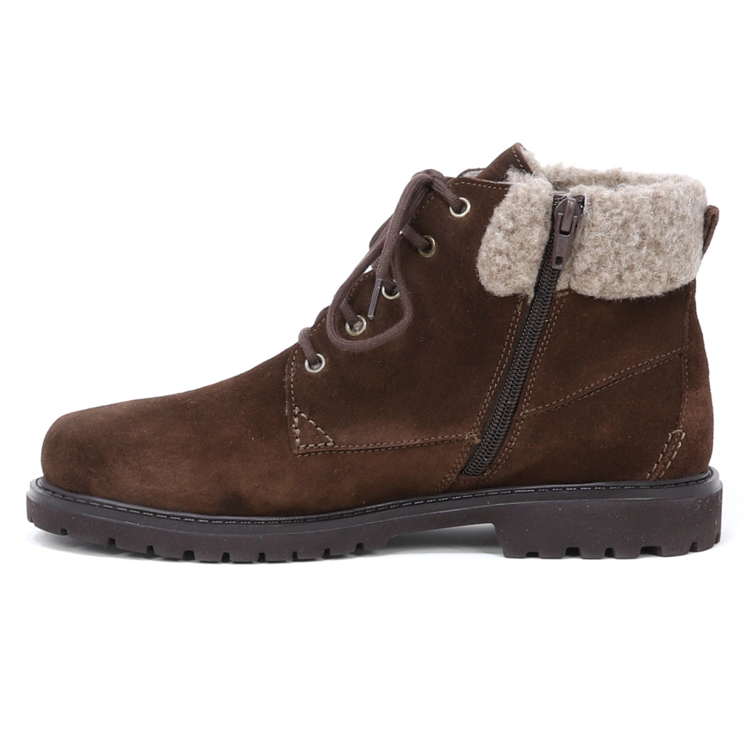 The Women’s Merano Chukka Boot features brown waterproof suede in an ankle silhouette, designed with a lace-up front, side zipper, and a light beige shearling collar for added warmth, displayed in a left-side profile on a white background.