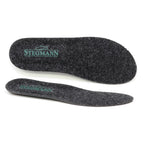 A pair of black felt Women's Wool Cushion Replacement Insoles - No Arch, featuring the word "Stegmann" and a green shoe graphic printed on the heel. These Stegmann replacement insoles deliver cushioned comfort, making them an ideal upgrade for your favorite shoes.