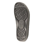 The image shows the black rubber sole of the Women's WoolFlex Wool Clog - Medium, featuring a hexagonal tread pattern with "BIRKENSTOCK" embossed in the center, designed for optimal support and podiatrist-recommended comfort.