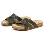 The Women's Romy Slide Sandal in green features cross-strap leather uppers, a contoured cork footbed, and textured brown outsoles, shown side by side on a white background.