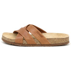 The Women's Romy Slide Sandal is shown in side profile, featuring brown leather with two wide crossed straps, a slightly raised heel, and a contoured cork footbed for comfort.