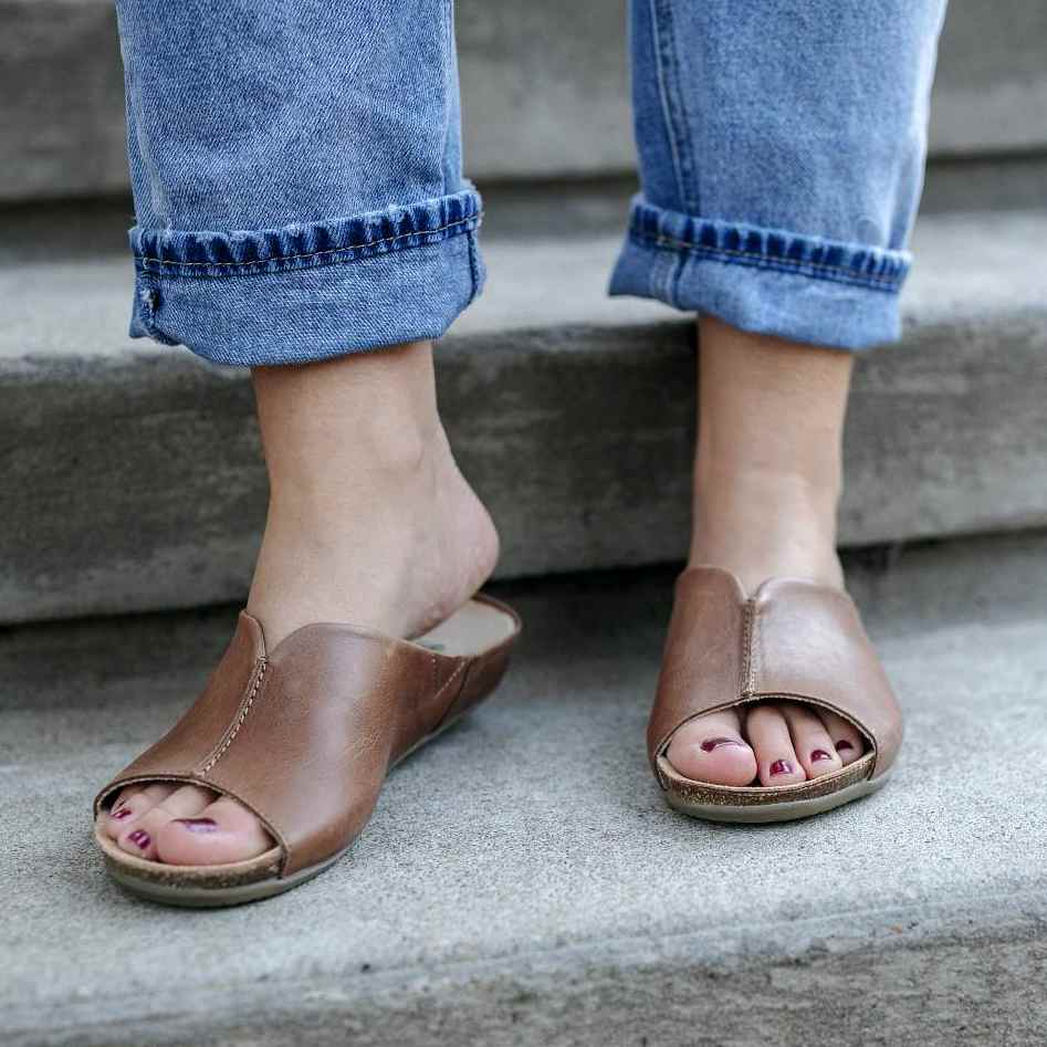The Mia slide is a mule style sandal with arch support. You'll be in awe of how comfortable and cute this sandal is. 