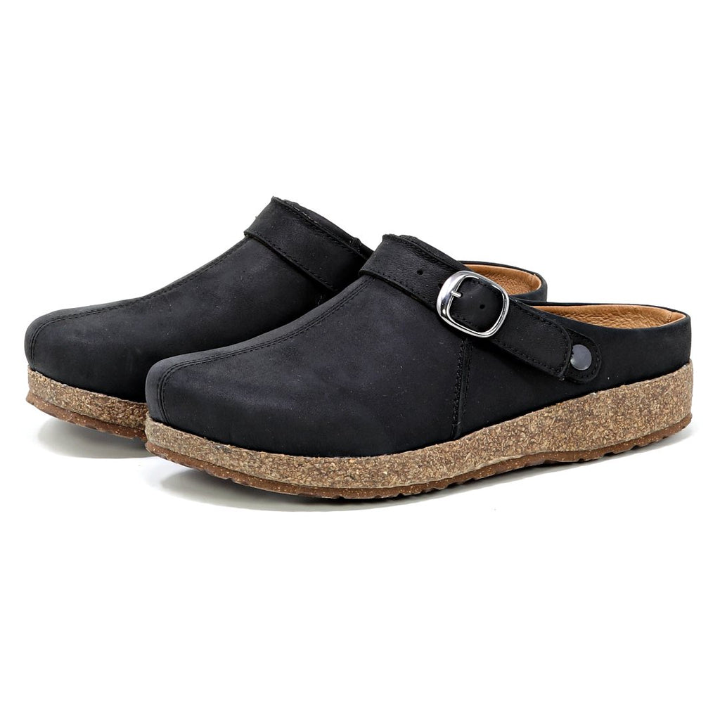 Viewed from the side, the Women's Tirol Leather Clog is a pair of black clogs made from oiled leather with an adjustable buckle strap and cork-like soles.