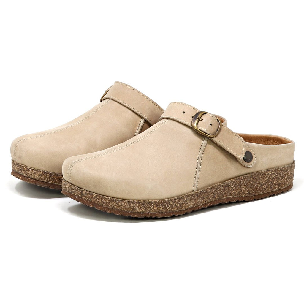 The Women's Tirol Leather Clog features beige suede with a wide toe box, adjustable strap, buckle detail, and a cork sole.