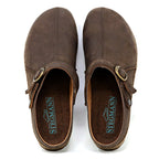 The Women's Tirol Leather Clog features brown oiled leather and an adjustable buckle strap. Its view from above shows "Stegmann" on the insole and a comfortable wide toe box.
