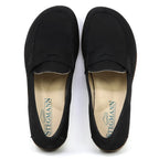 The Women's Victoria Loafer is a sleek pair of black nubuck loafers with tan insoles, labeled "Stegmann," offering excellent arch support for all-day comfort.