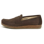 The Women's Victoria Loafer is a brown nubuck slip-on shown in profile on a white background. It features a cork sole, stitched seam across the top, shock-absorbing midsole, and offers ultimate arch support for all-day comfort.