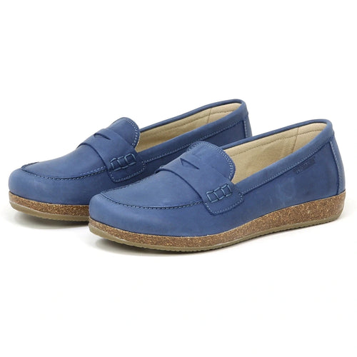 A pair of Women's Victoria Loafers in blue nubuck with tan cork soles, stitched accents, cushioned insoles, and a soft lining are displayed side by side on a white background.