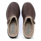 A pair of Zermatt Wool Shearling Clogs in brown, featuring buckle detail and plush beige wool shearling lining, viewed from above. The brand name “STERLING” is visible on the insoles.