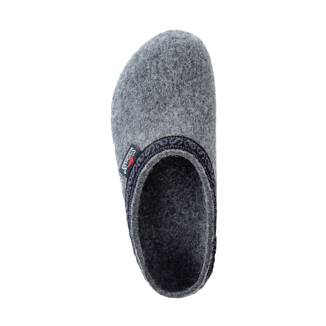 A side view of the Women's Original 108 Wool Clog - Wide displays a single gray slipper with dark trim around the opening, crafted from luxurious Merino wool felt and featuring a supportive sole for enhanced comfort.