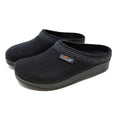 The Women's WoolFlex Wool Clog - Wide are black slip-on slippers made of Merino wool, featuring a subtle edge pattern, arch support, and a side brand label.