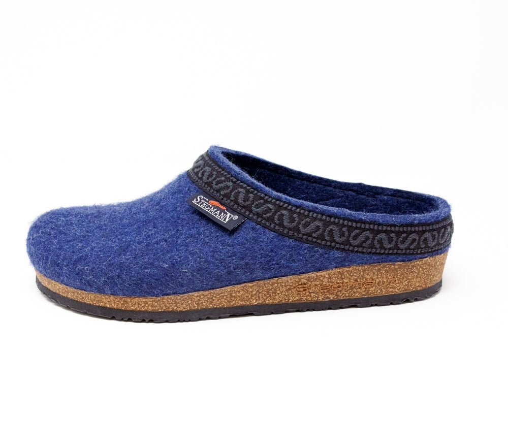 Women's shoe: The Women's Original 108 Wool Clog - Medium, a blue woolen slipper with a black patterned trim and cork & latex sole, elegantly crafted from Merino wool felt against a pristine white background.