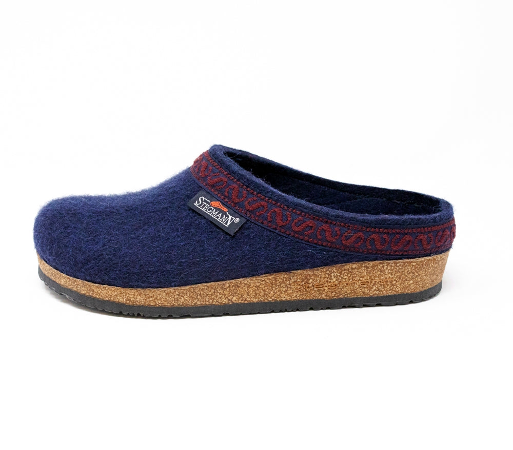 The Women's Original 108 Wool Clog - Medium is a solo shoe made from Merino wool felt, showcasing a blue clog design with red patterned trim and a cozy cork & latex sole, set against a clean white background.