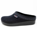 The Women's WoolFlex Wool Clog in medium size features a black Merino wool upper with decorative collar patterns, an anatomically contoured sole for cushion comfort, and a side brand label.
