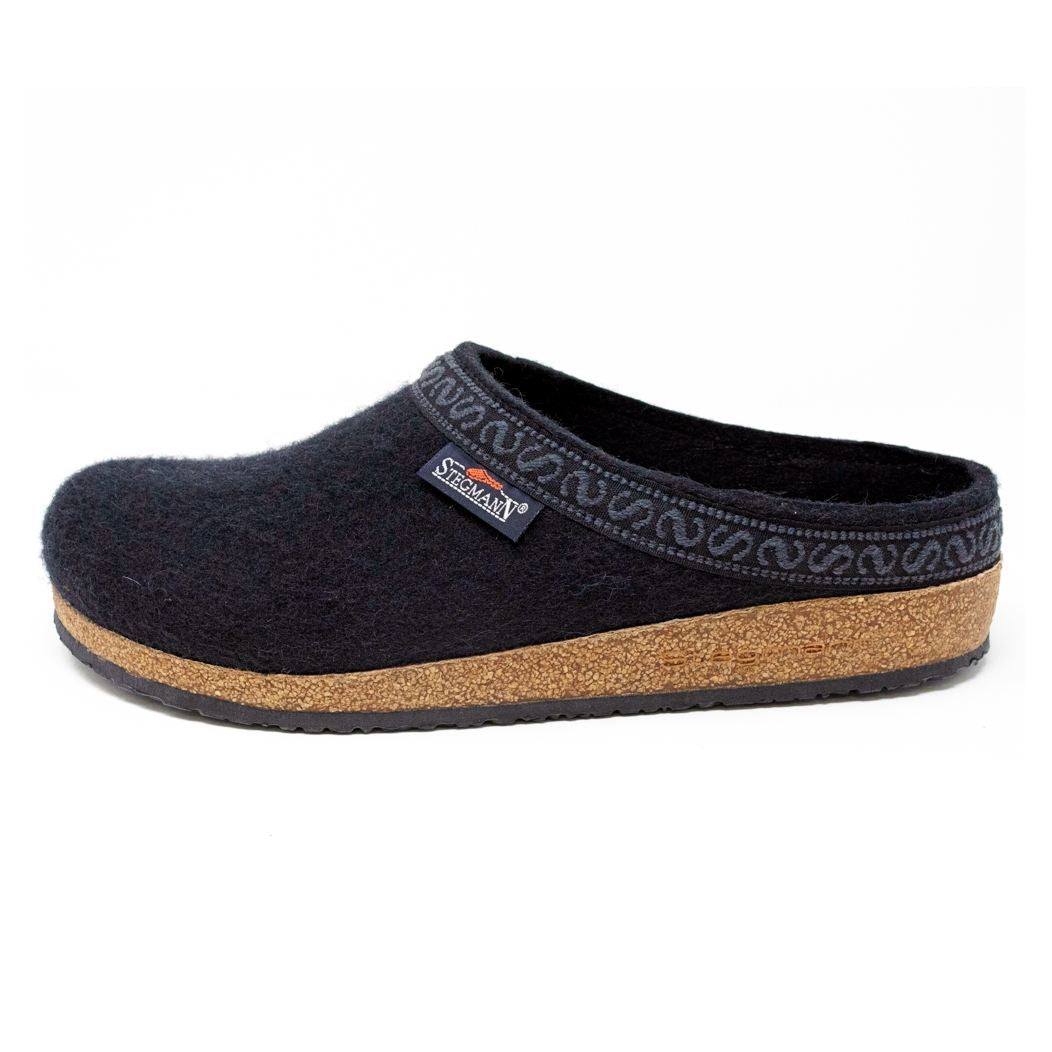 The Men's Original 108 Wool Clog is a black felt slipper designed for men, featuring a supportive cork sole, decorative trim on the upper edge, and luxurious Merino wool for enhanced comfort.