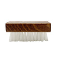 The Wool & Felt Care Brush, shown from the side with a wooden handle and white bristles, is essential for maintaining your wool or Stegmann Clogs' pristine appearance.