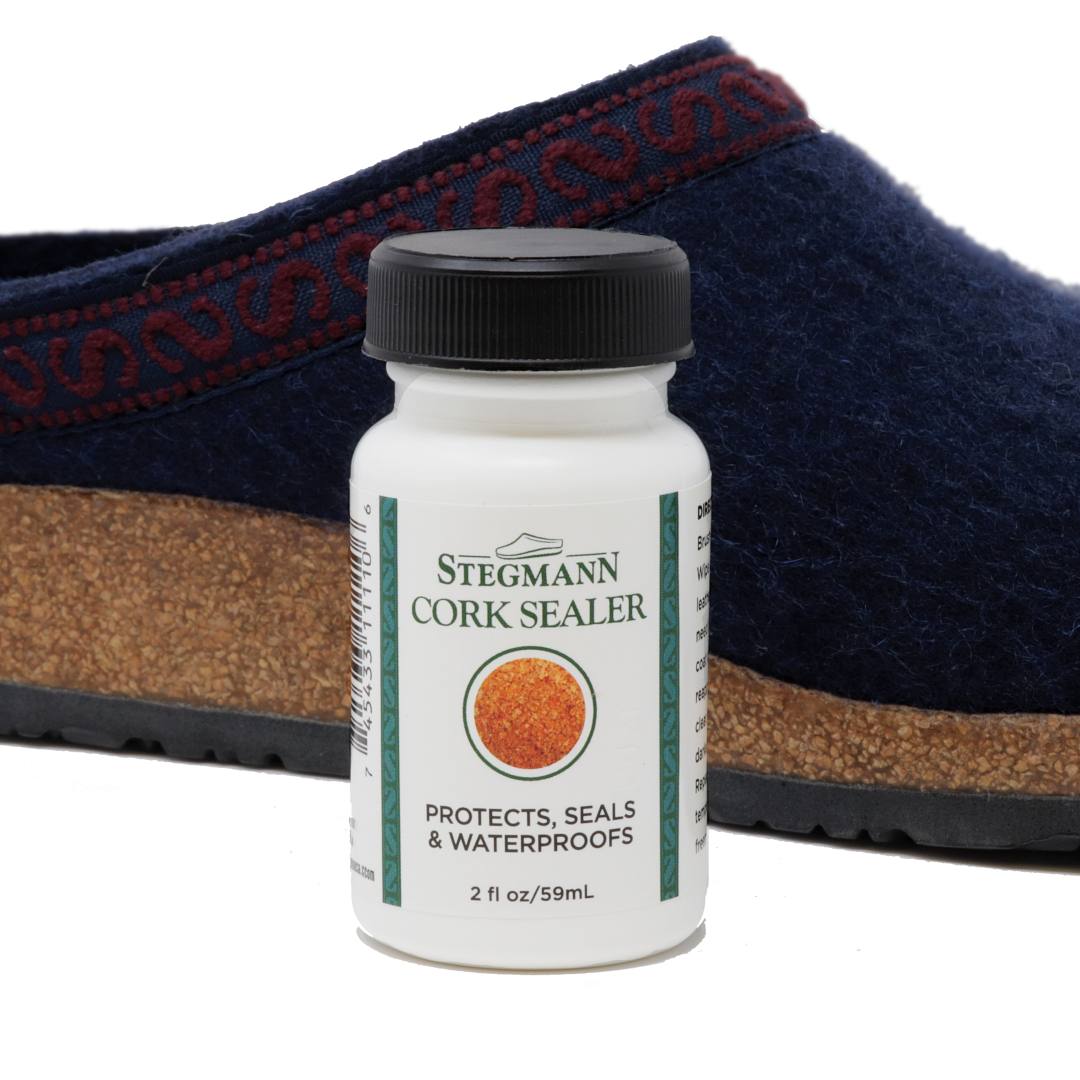 A Stegmann Cork Sealer bottle stands before a blue wool shoe with cork sole, promising to "Protect, Seal & Waterproof," keeping footbeds pristine.